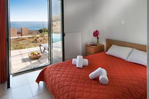 a bedroom with a bed with two towels on it at Superior Villa Lino in Skiros
