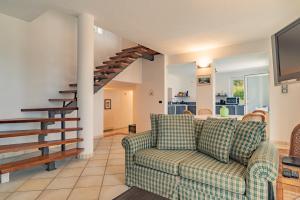 a living room with a couch and a staircase at Bike e Relax Villa in Bardino Vecchio