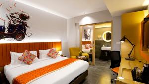 a hotel room with a bed with a motorcycle on the wall at City Keys Bangalore By Bestinn Leisure in Bengaluru