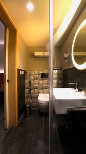 a bathroom with a white sink and a toilet at Hotel City Keys By Rivido, Electronic City in Bangalore