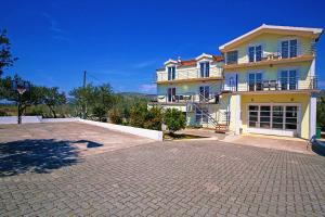 a large house with a large driveway in front of it at Villa Tea in Donje Polje