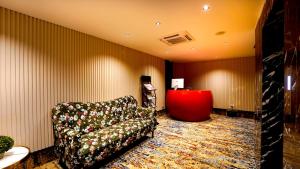 a living room with a couch and a red table at Hotel City Keys By Rivido, Electronic City in Bangalore