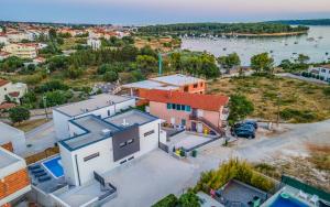an aerial view of a house with a view of the water at Villa RougeMarin - Rouge with private pool in Medulin
