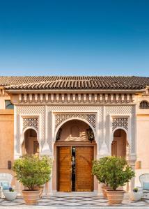 a building with a wooden door with two plants at One&Only The Palm Dubai in Dubai