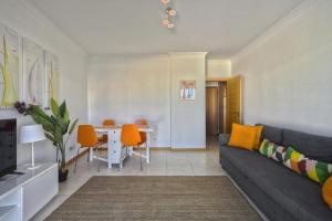 a living room with a couch and a table at Apartamento Varandas do Mar in Albufeira