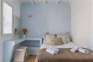 A bed or beds in a room at Ninemia Suites Tinos Superior 102