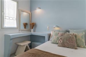 A bed or beds in a room at Ninemia Suites Tinos Superior 102