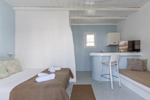 A bed or beds in a room at Ninemia Suites Tinos Superior 102