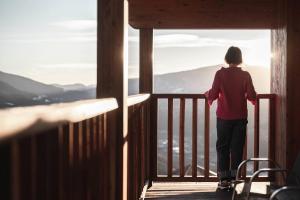 a person standing on a skateboard on a balcony at Hotel Fernblick in Bressanone