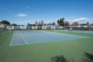 a tennis court with a tennis ball on it at Mobile-home 132 in Lattes