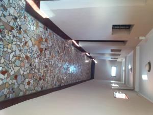 a hallway with a wall of glass mosaic tiles at K6 Chambres d'Hôte in Ivato