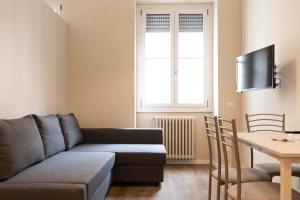 a living room with a couch and a table at Missori Apartment 2 in Milan