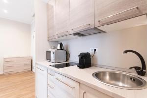 a kitchen with a sink and a microwave at Missori Apartment 2 in Milan