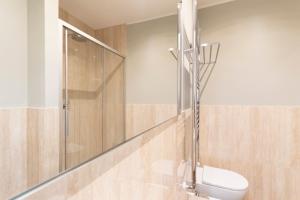 a bathroom with a shower and a toilet at Missori Apartment 2 in Milan +13 photos