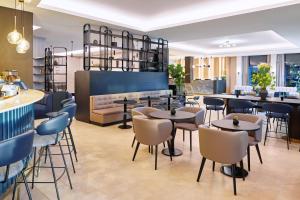 een restaurant met tafels en stoelen en een bank bij Maistra City Vibes Hotel International in Zagreb