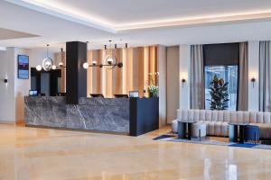a lobby of a hotel with a reception desk at Maistra City Vibes Hotel International in Zagreb