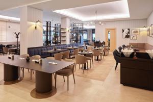 a dining room with tables and chairs in a restaurant at Maistra City Vibes Hotel International in Zagreb