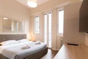 米兰Missori Apartment 1的卧室里有一张床，床上放着两条毛巾。