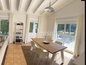 a living room with a table and a couch at Villa Brisa Marina in Calonge +25 photos