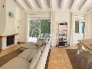 a living room with a couch and a fireplace at Villa Brisa Marina in Calonge