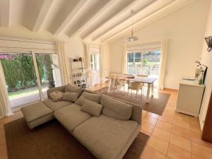 a living room with a couch and a table at Villa Brisa Marina in Calonge