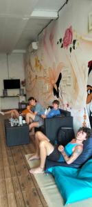 a group of people sitting in a room at Tara hostel in Nusa Penida