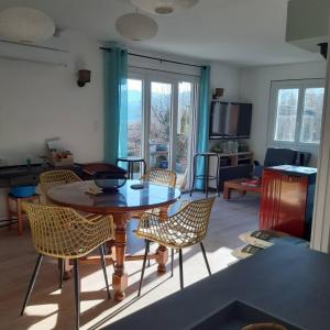 a living room with a table and chairs at PILOUBELLE 