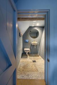 a bathroom with a toilet and a sink at The Carpenters Arms in Great Wilbraham