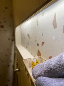 a bathroom counter with a wall with a mirror at Villa Pantheon in Litochoro