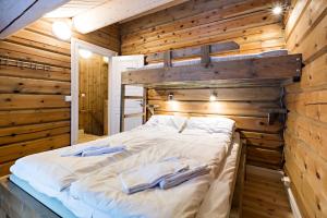 a bedroom with a bed in a wooden wall at Lake View Apartment 2 bedrooms in Sykkylven