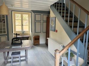 a room with a staircase with a table and a stair case at Le Chambellan in Coux-et-Bigaroque