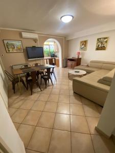 a living room with a couch and a table at Apartments Oliva in Poreč