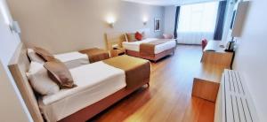 a hotel room with two beds and a living room at Silivri Park Hotel in Silivri