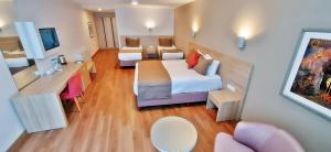 a small room with a bed and a table and chairs at Silivri Park Hotel in Silivri