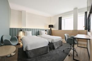 Rúm í herbergi á Radisson Blu Hotel, Hasselt