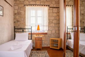 1 dormitorio con 2 camas y ventana en Marvelous Stonehouse With Backyard and Fireplace in Alacati Cesme, en Alacati