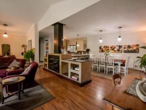 a living room with a kitchen and a dining room at Rooiland Clarens in Clarens