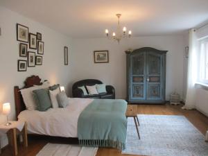 a bedroom with a bed and a chandelier at La maison de Lili in Guebwiller