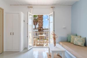a living room with a couch and a table at Ninemia Suites Tinos Grand 104 in Kionia