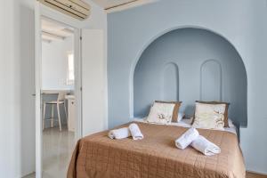 1 dormitorio con 1 cama con 2 toallas en Ninemia Suites Tinos Grand 104 en Kionia