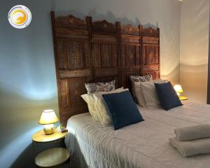 a bedroom with a large bed with a wooden headboard at Azor International Apartment I in Ponta Delgada