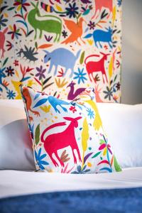 a pillow sitting on top of a bed with a floral pattern at The Carpenters Arms in Great Wilbraham