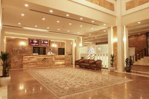 a lobby with a couch and a bar in a building at Sun Erbil in Erbil