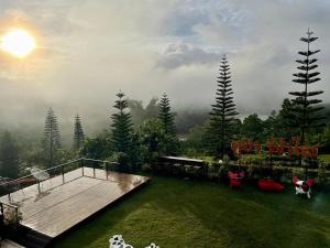 a view of a garden with a deck and trees at Phuyafahsai The Resort Khao Kho in Khao Kho
