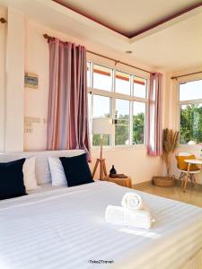 1 dormitorio con 1 cama con 2 toallas en Phuyafahsai The Resort Khao Kho en Khao Kho