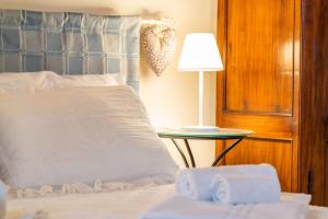 a bedroom with a bed with a table and a lamp at Iesa - Relax nella campagna di Siena in Lama