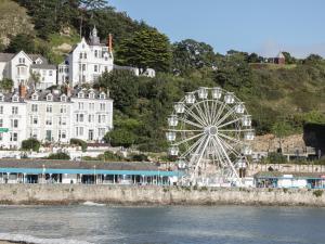 a ferris wheel in front of a large white building at 50A Lloyd Street West in Llandudno