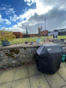 a black umbrella sitting on top of a stone wall at Minton cottage in Leadhills