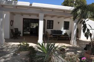 a white house with a patio with a couch at La Madrugada Formentera by Tentol Hotels in Sant Ferran de Ses Roques