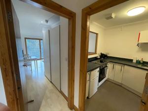 a kitchen with white appliances and a dining room at Lovely studio Apartment with balcony in Norwich